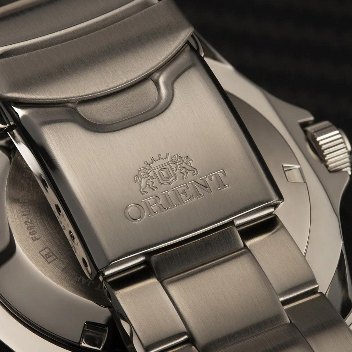 Stainless steel watch clasp with Orient logo engraving and link bracelet section.
