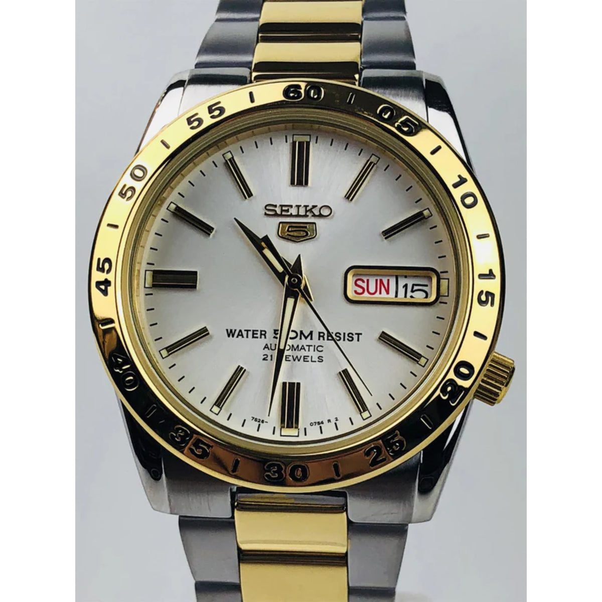 Two-tone men’s automatic watch with white dial, gold bezel, and SUN 15 day-date window