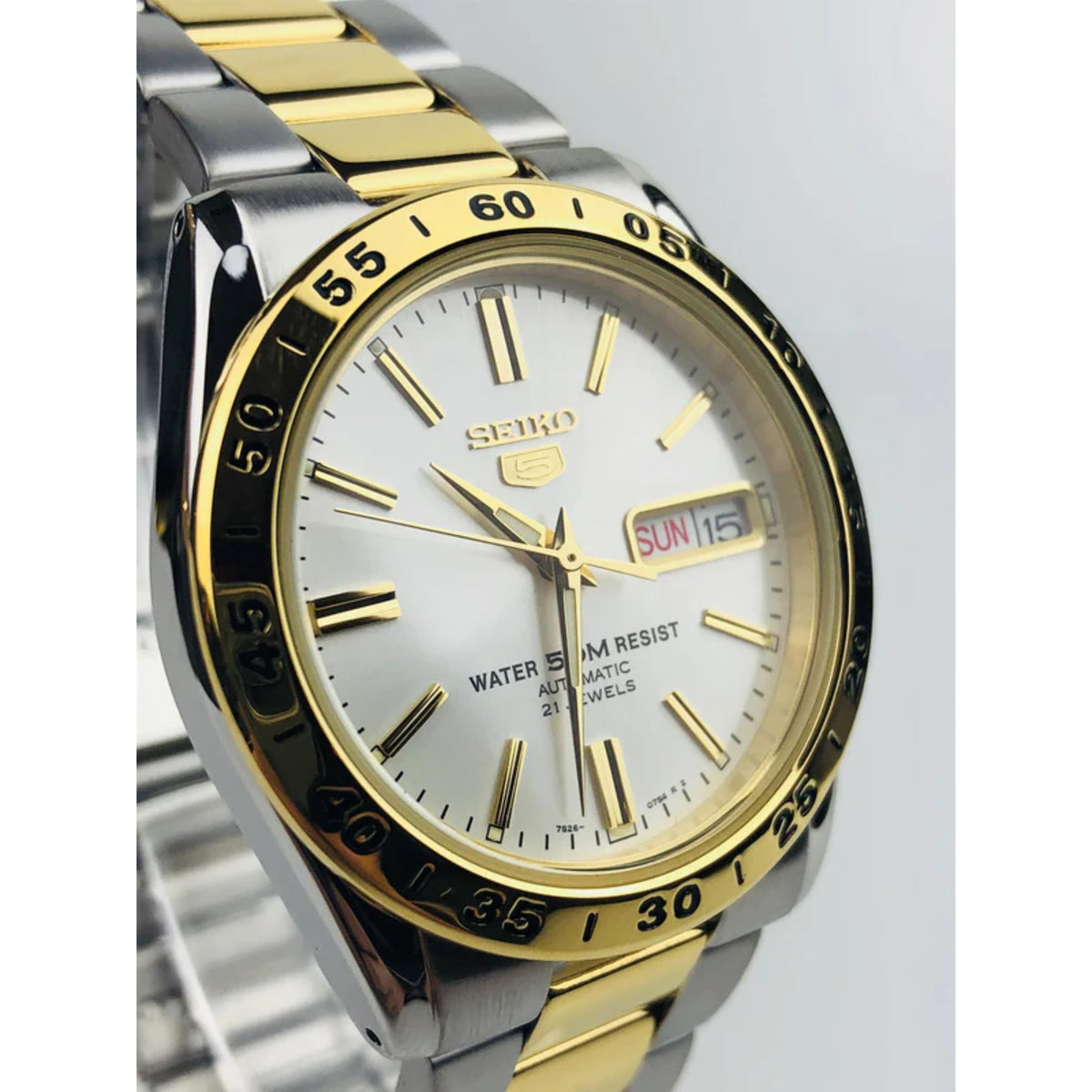 3/4 view two-tone stainless steel watch with white dial, gold bezel, and gold bracelet links