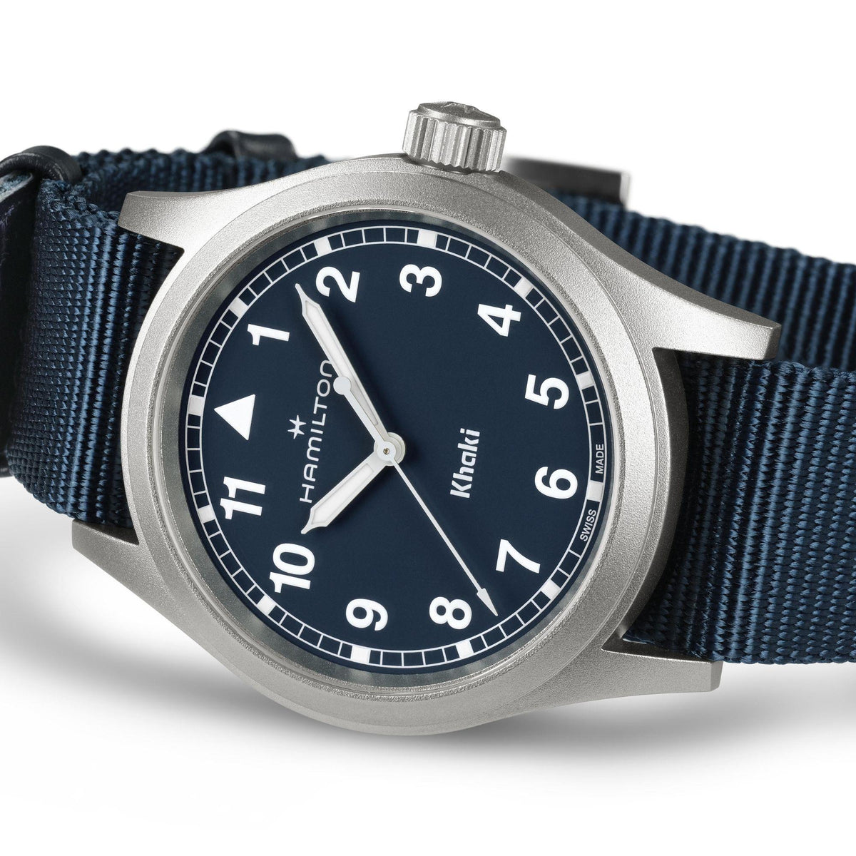 Blue-faced quartz watch with silver hands and markers, dark blue fabric NATO strap