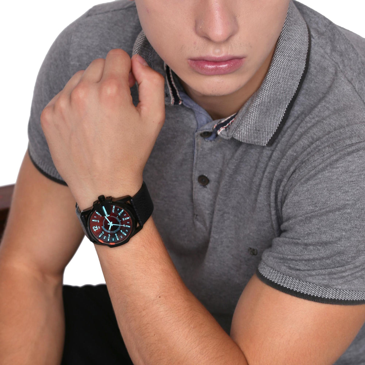 Men's quartz watch on wrist with black leather strap and black dial with orange numerals