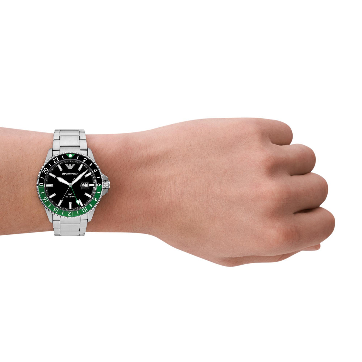 Men's steel watch on wrist, black dial with green bezel and metal bracelet