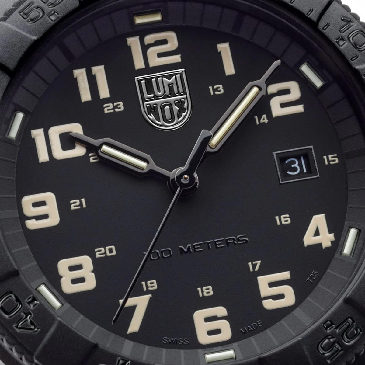 Close-up of black dial with luminous numbers, gold-tone hands and date