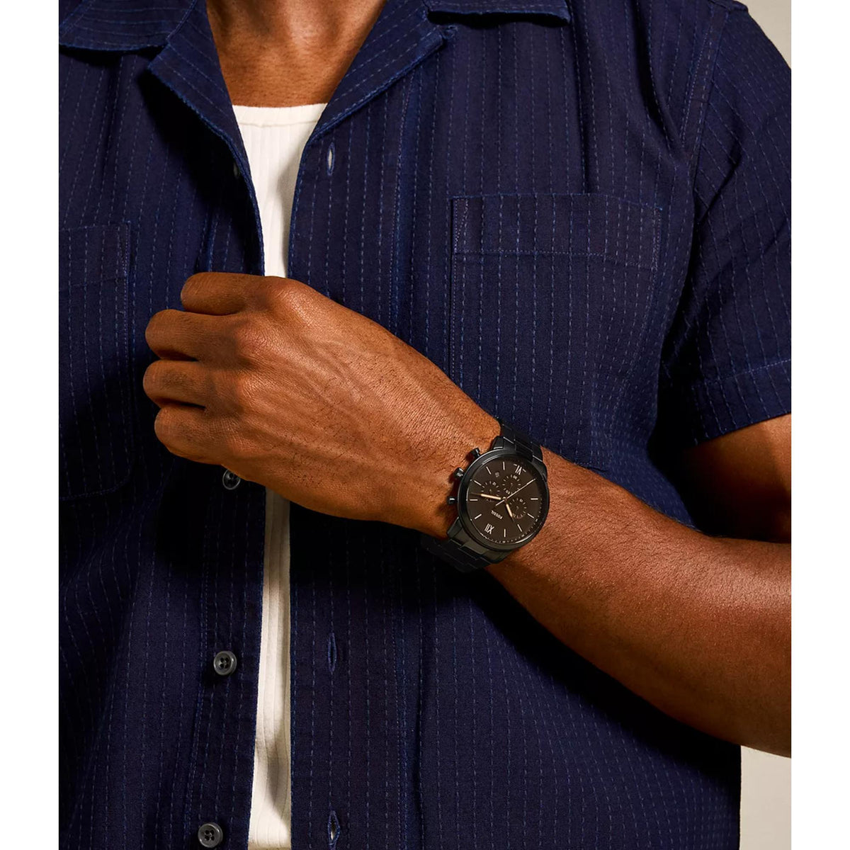 Men's wrist wearing black dial chronograph quartz watch with black metal bracelet
