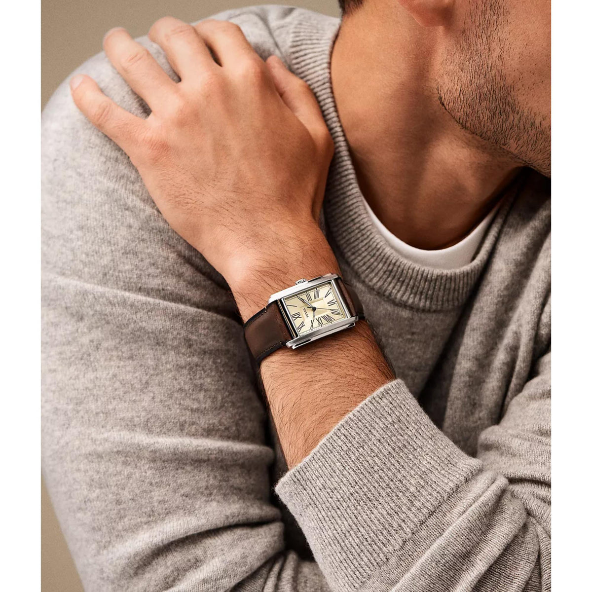Fossil Carraway FS6012 30mm tank watch styled on a wrist, displaying a rectangular steel case and brown leather strap