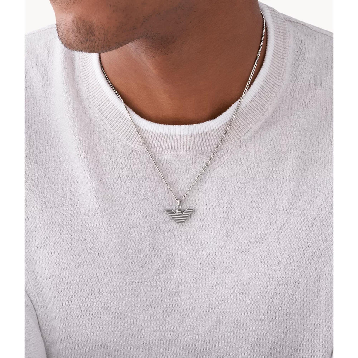 Stainless steel pendant necklace with V-shaped eagle wing charm worn on a man