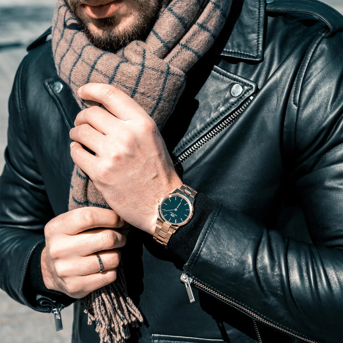 Mens wristwatch on a wrist, teal dial with metal link bracelet and crown