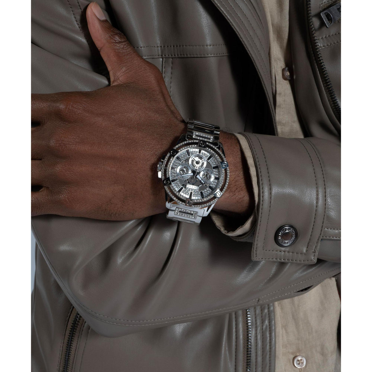 Men’s silver crystal multifunction watch on wrist, steel bracelet and subdials