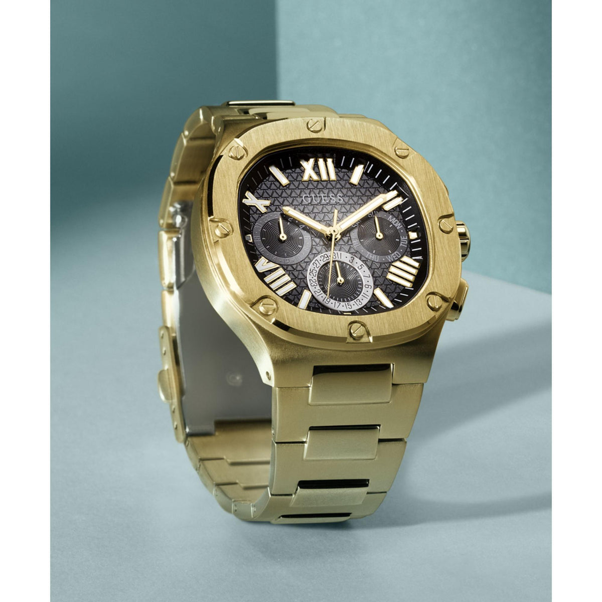 Gold tone men's watch with black dial, gold hands, and three subdials on metal bracelet