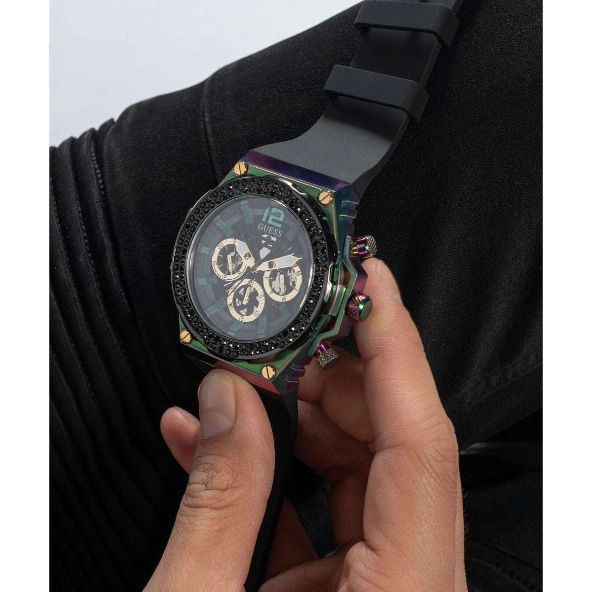 Men's wristwatch on black sleeve, black dial with gold accents and multicolor case trim