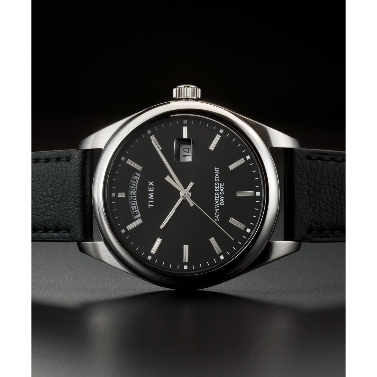Timex quartz watch with black dial, silver hands, date window, black leather strap