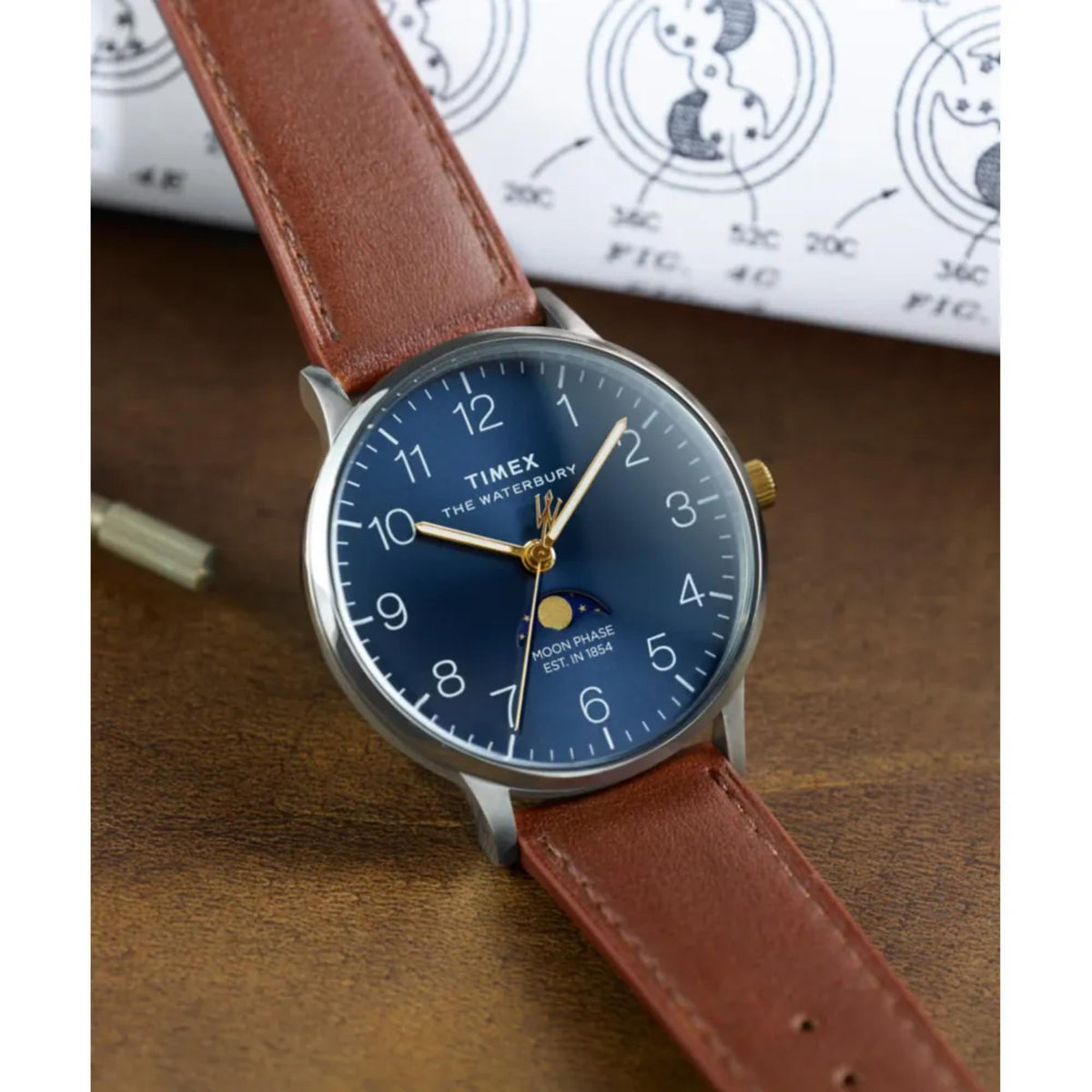 Men's blue dial quartz watch with brown leather band and gold-toned crown