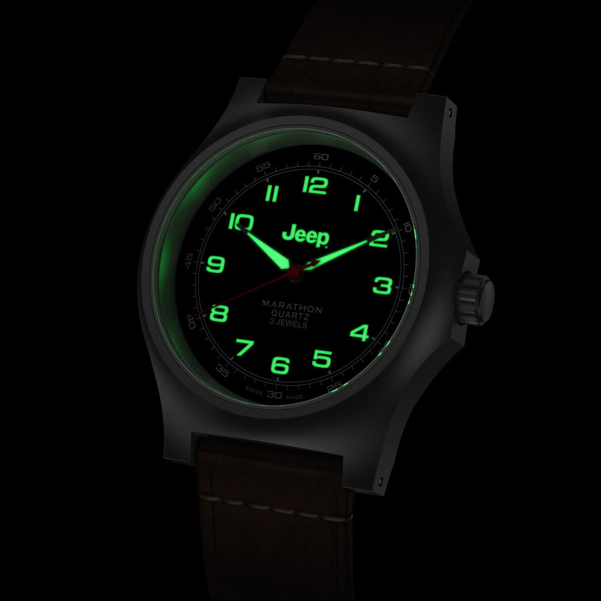 Men's quartz wristwatch with illuminated green dial and black face; brown leather strap.