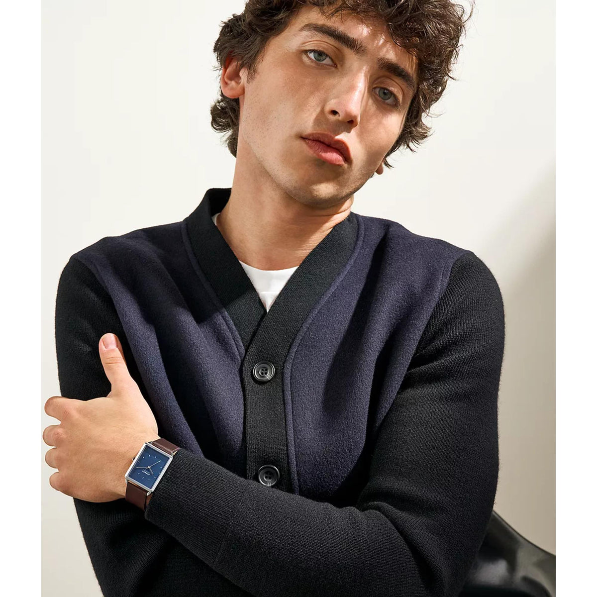 Man wearing Skagen watch with brown leather strap and blue dial on wrist