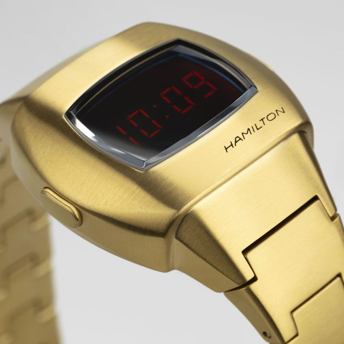 Gold PVD digital watch case with black screen and red LED numbers