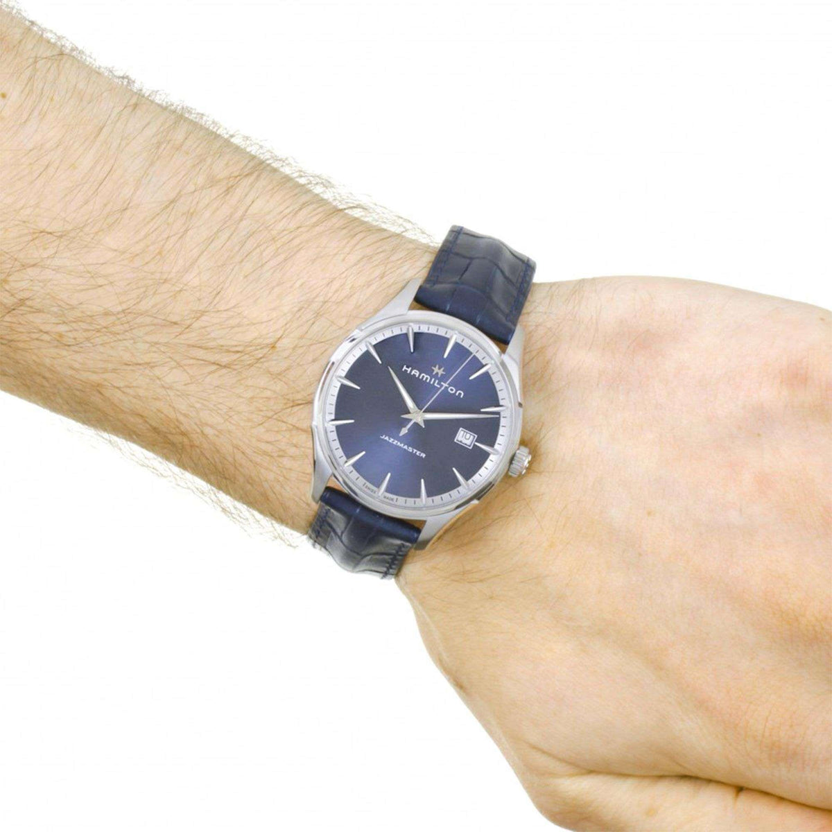 Men's wrist quartz watch with blue dial and dark blue leather strap on arm