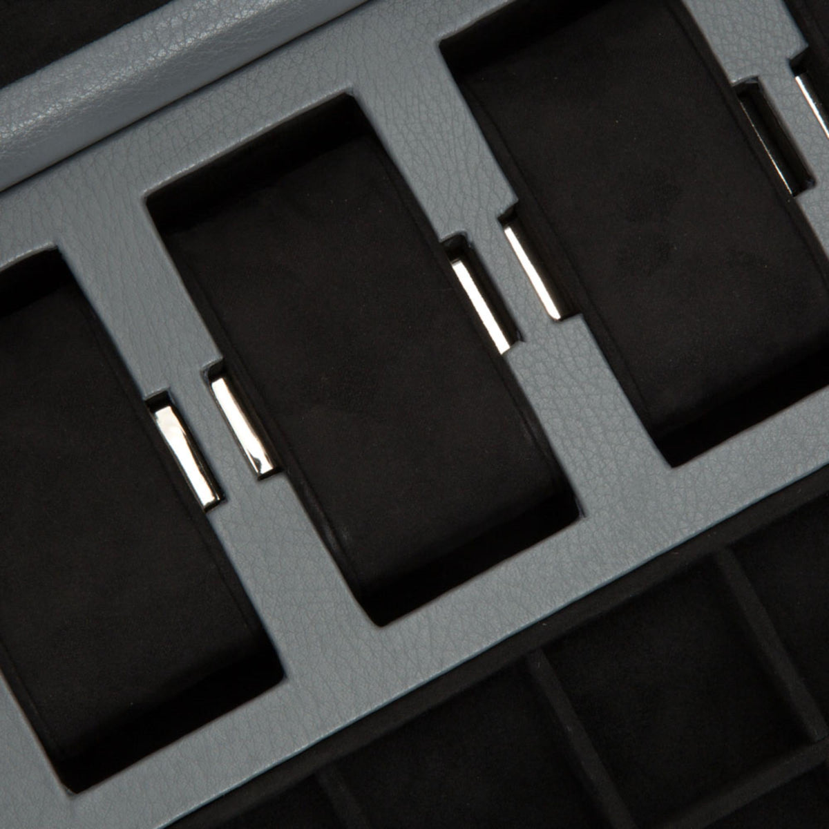 Wolf Howard watch box interior close-up of black slots with gray dividers and metal accents