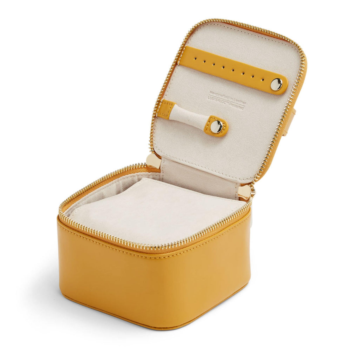 Mustard yellow jewelry cube open with beige lining, gold snap tab and zippered compartments