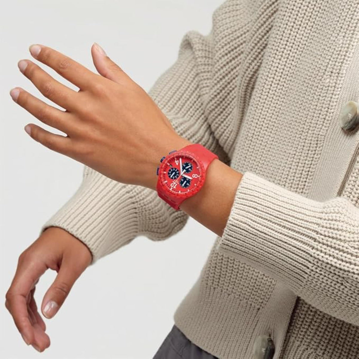 Red chronograph wristwatch with blue dial details on a silicone strap