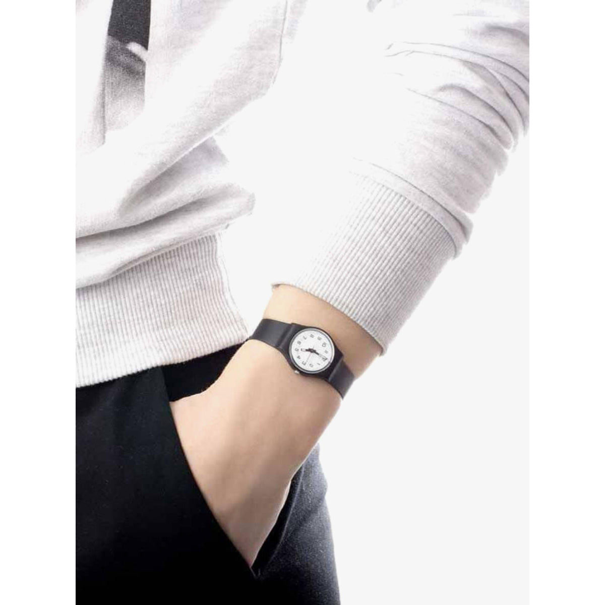 Black strap wristwatch with white dial on a person’s arm