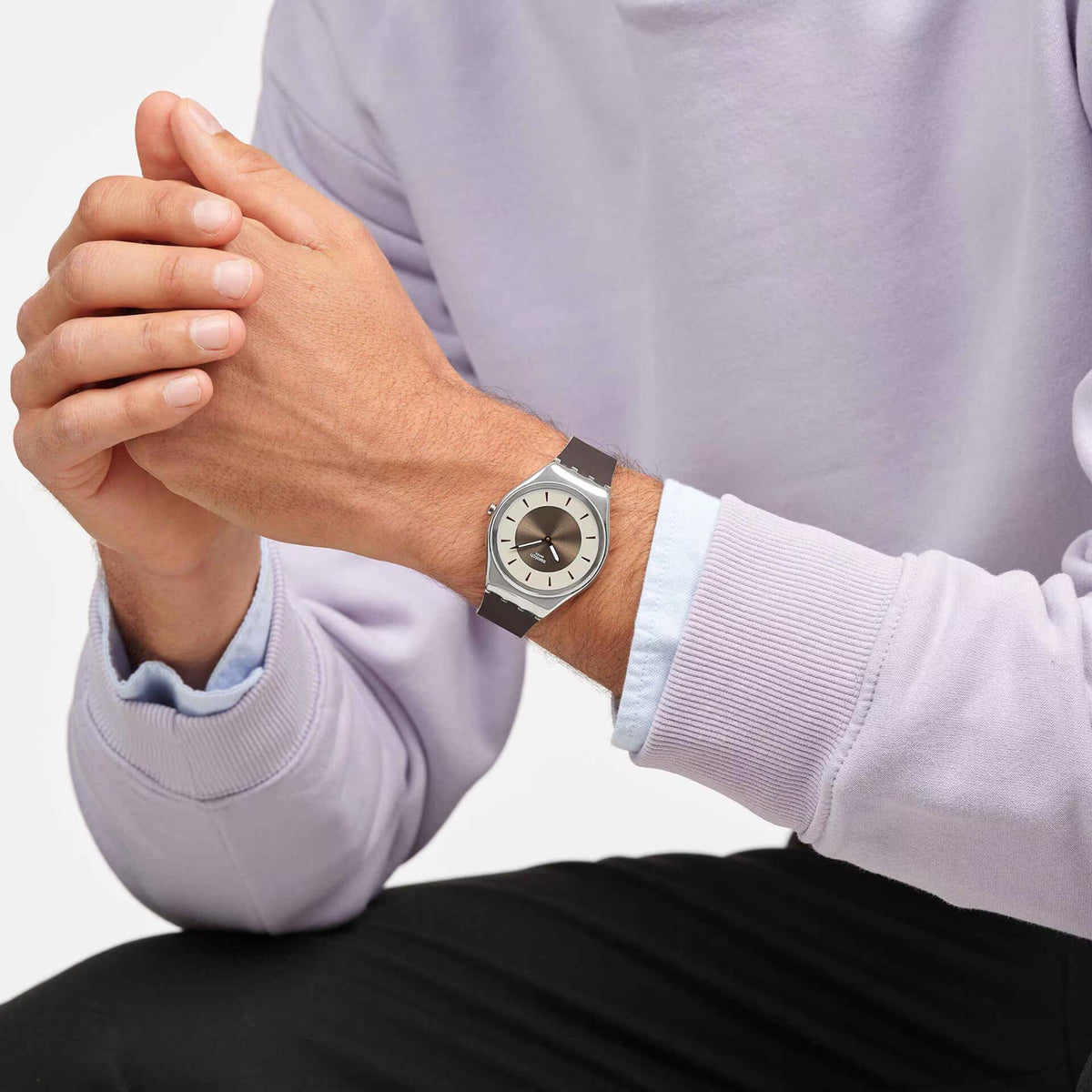 Swatch wristwatch with dark brown silicone band and bronze dial, silver-tone round case