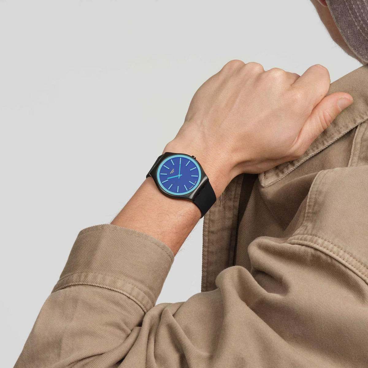 Black strap watch with blue shimmer dial and turquoise index markers