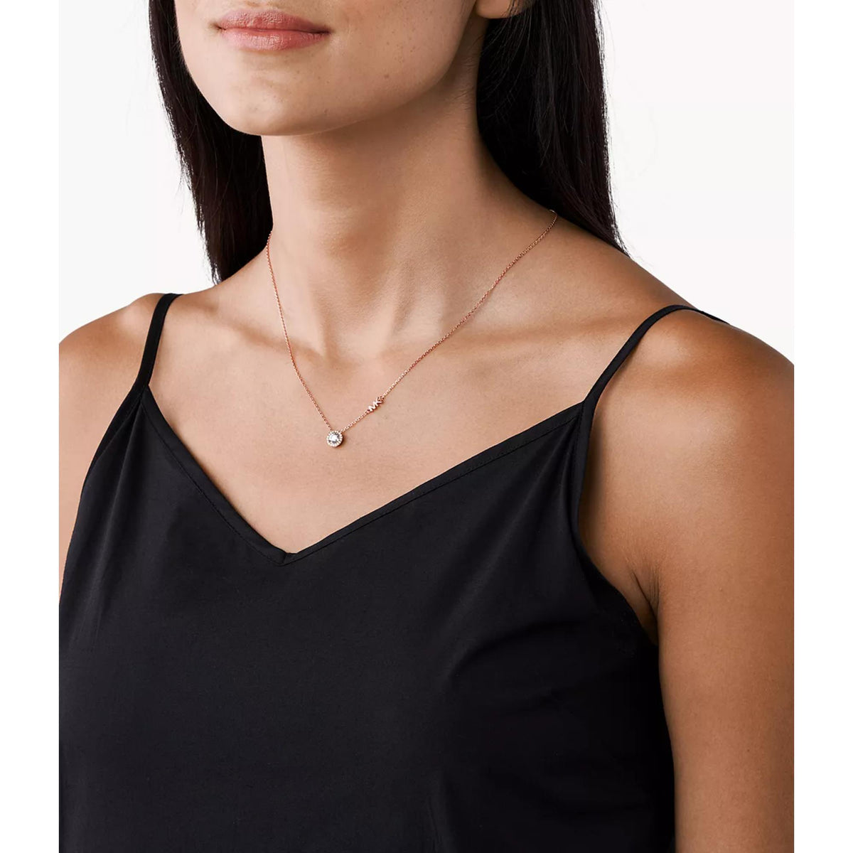 Rose gold-plated CZ pendant necklace worn by model, round halo pendant at center