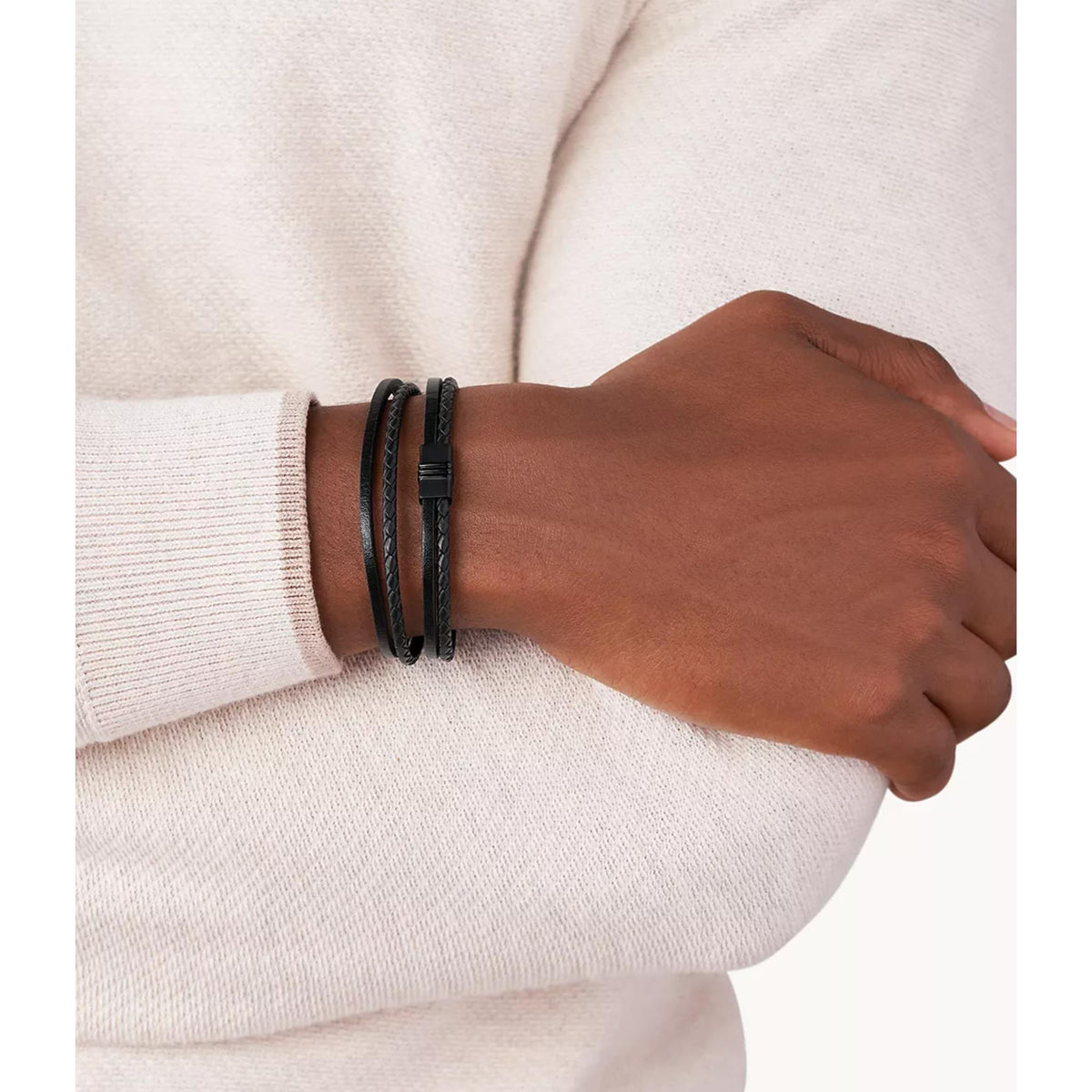 Black leather multi-strand bracelet worn on wrist over a light sweater sleeve