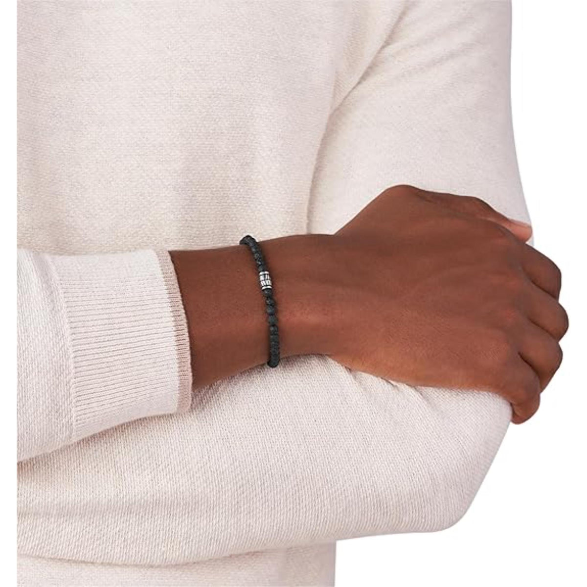 Men's black bead bracelet worn on wrist with white long-sleeve shirt cuff