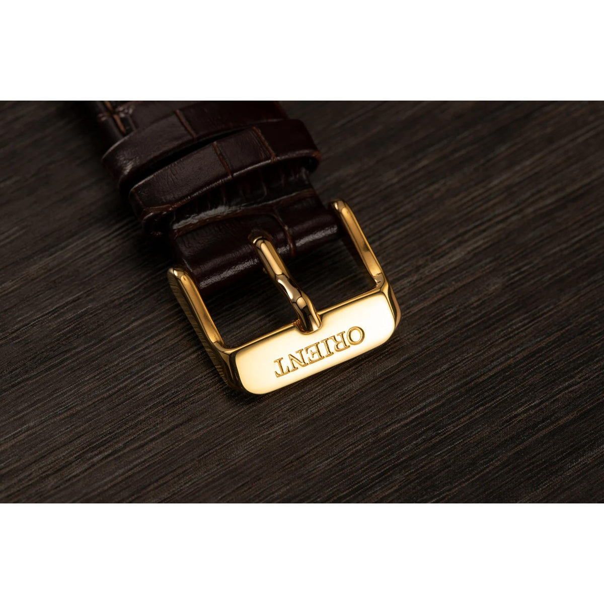 Brown leather watch strap with gold-tone buckle and metal keeper
