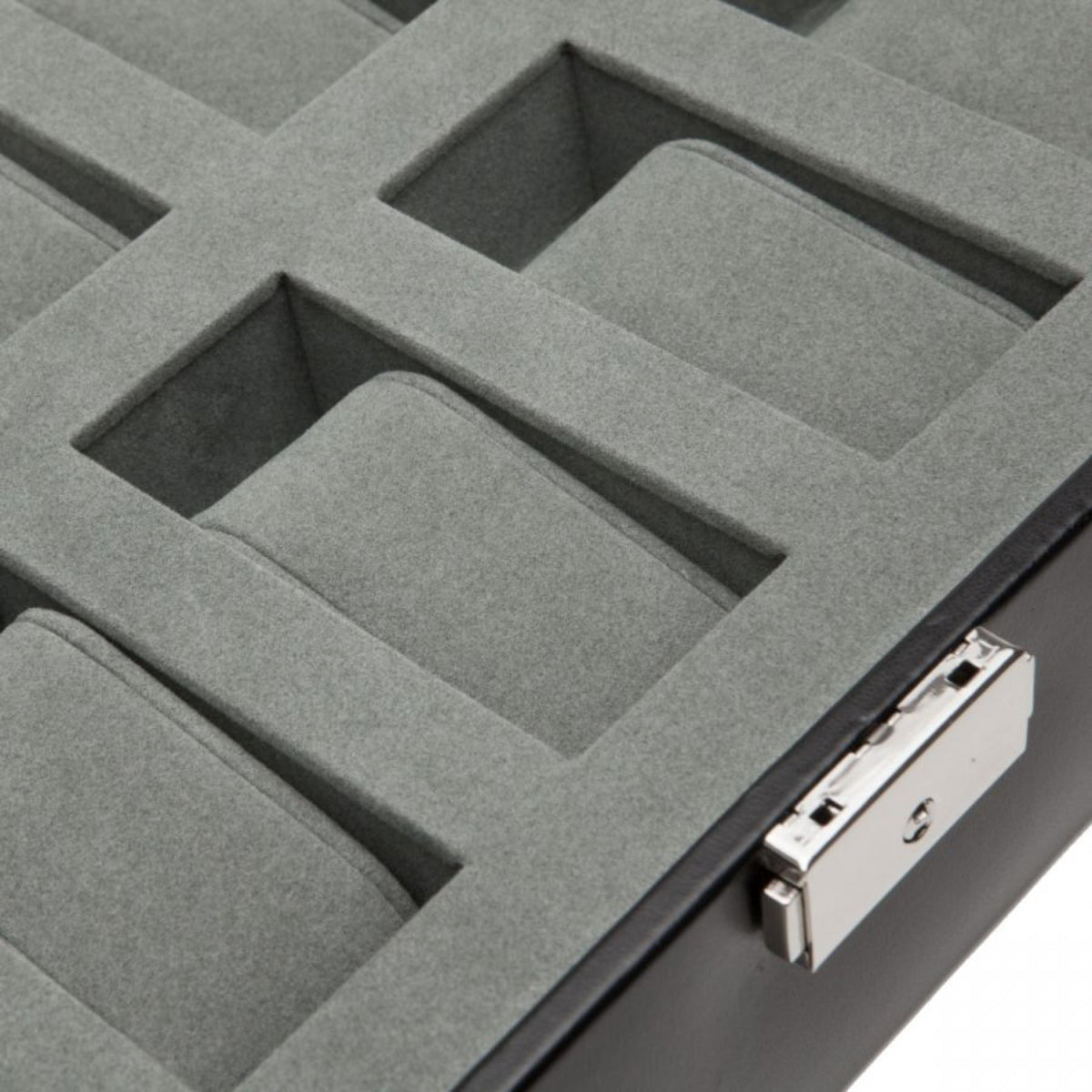 Watch box organizer insert close-up with gray padded compartments and latch.
