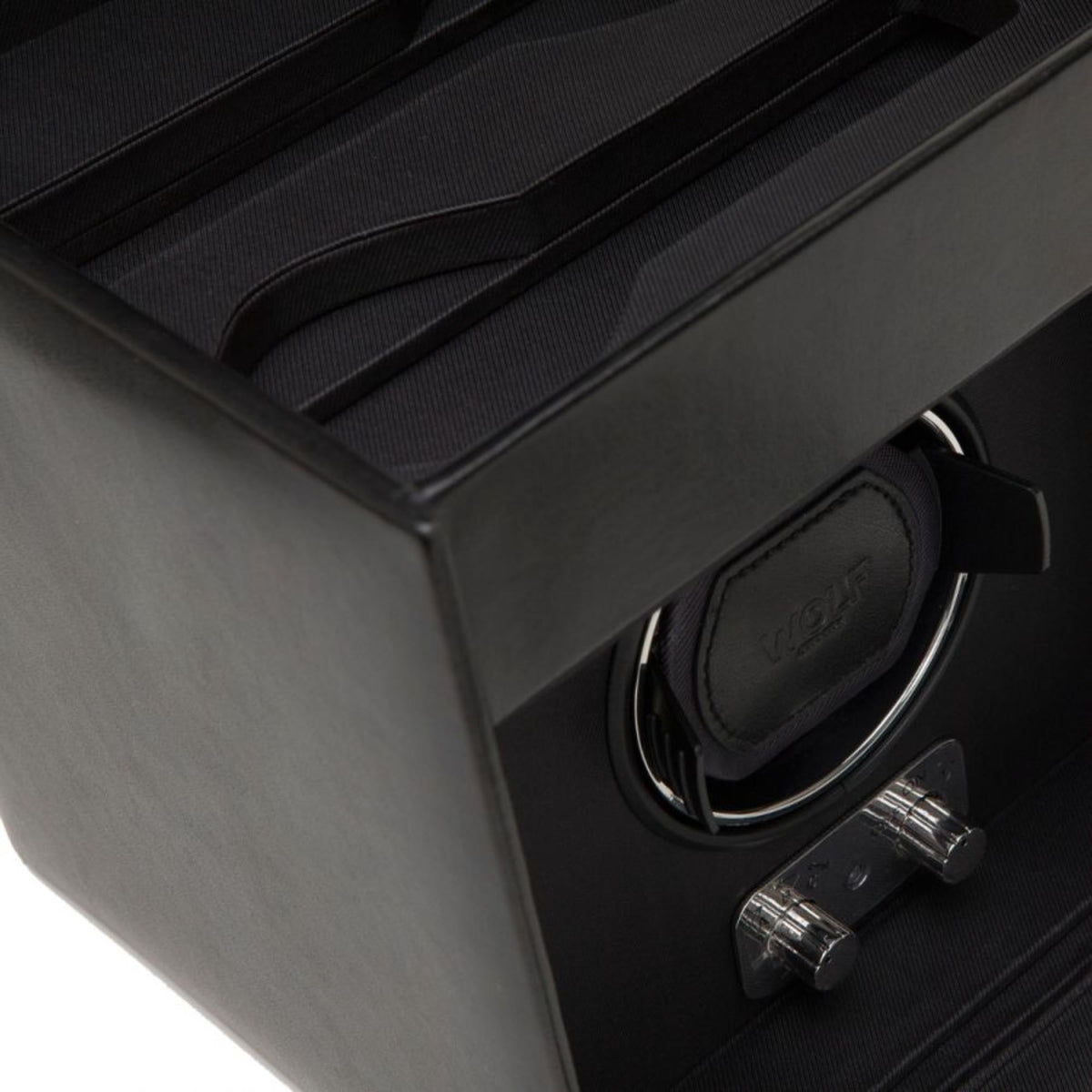 Black watch winder interior with circular holder and two metal winding knobs