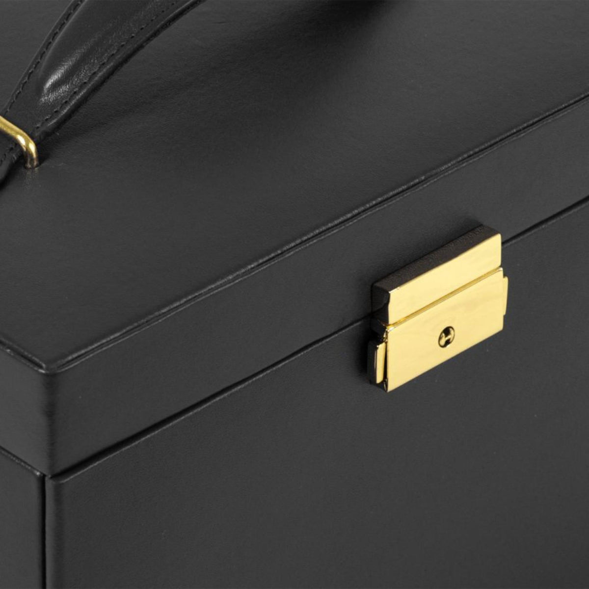 Close-up of black leather jewelry box front latch with gold clasp