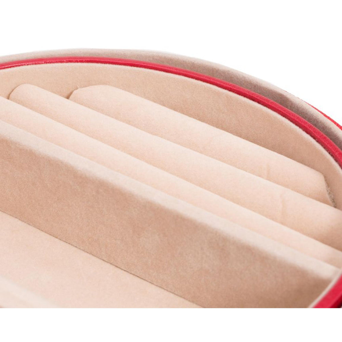 Close-up of beige padded interior with ridged rows inside the red jewelry box
