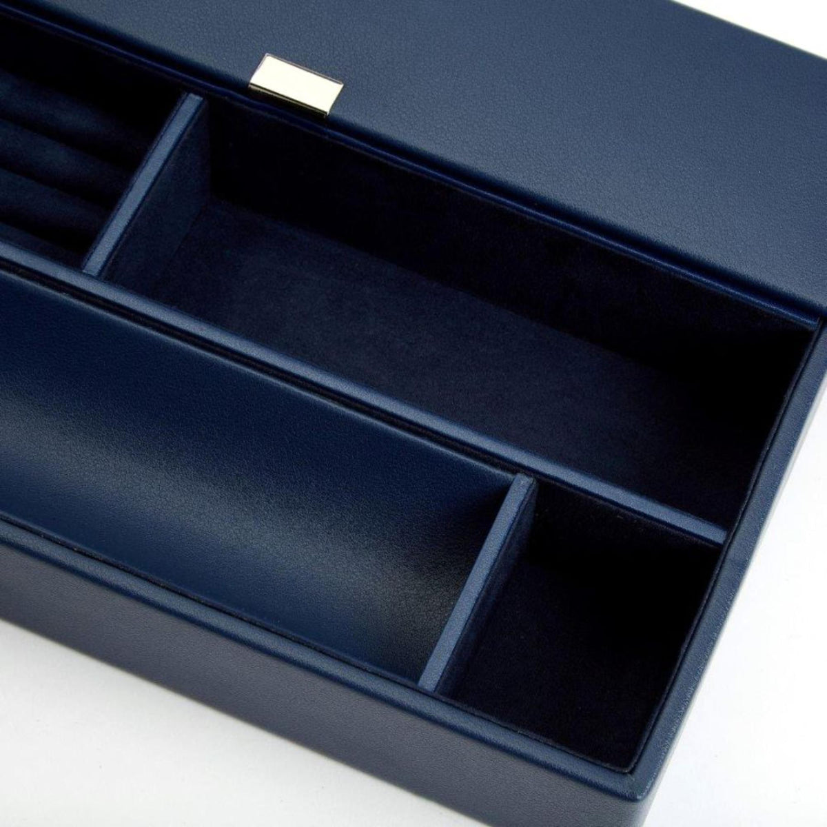 Close-up of navy leather valet tray interior slots and divider tray