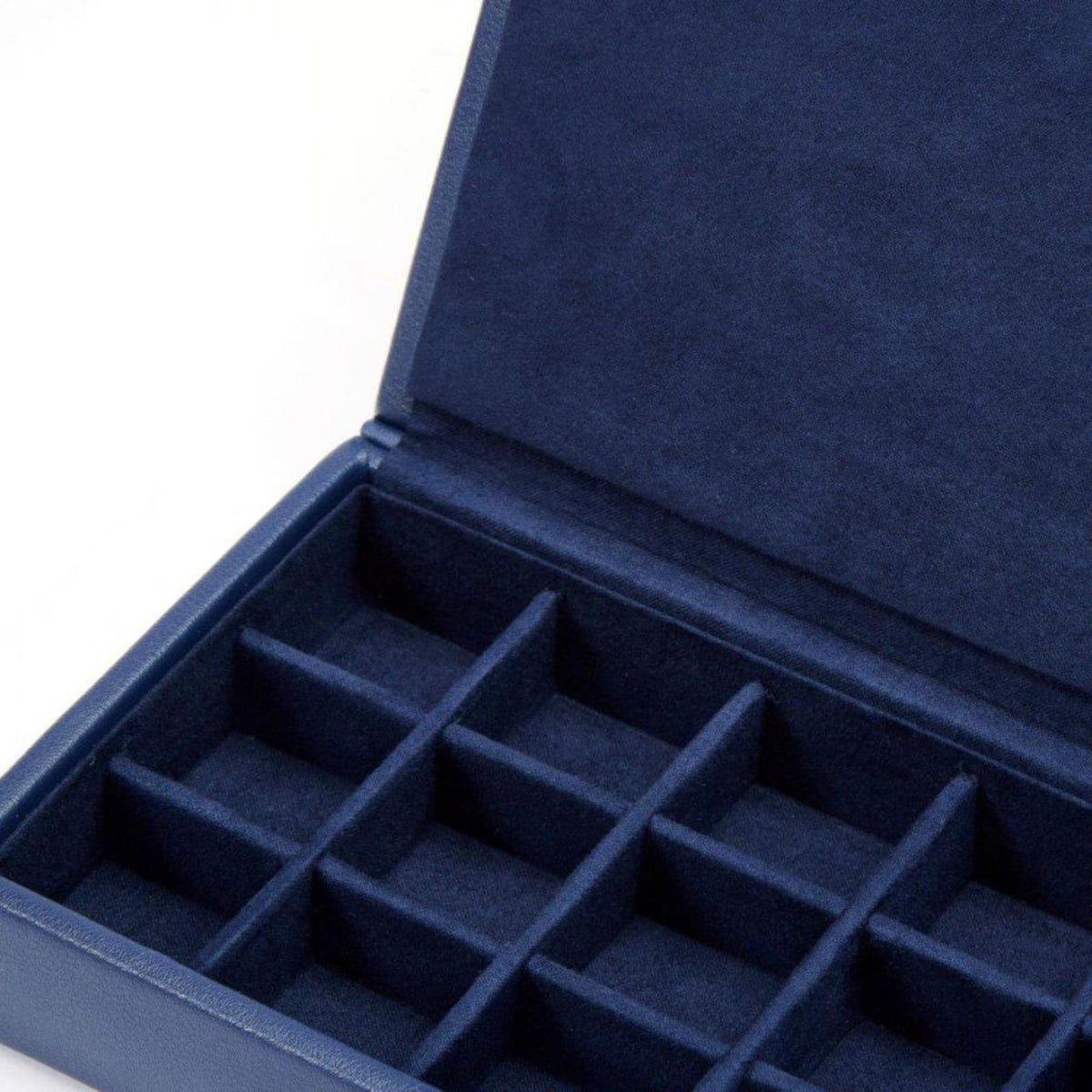 Navy leather cufflink box interior with padded dividers in a grid layout