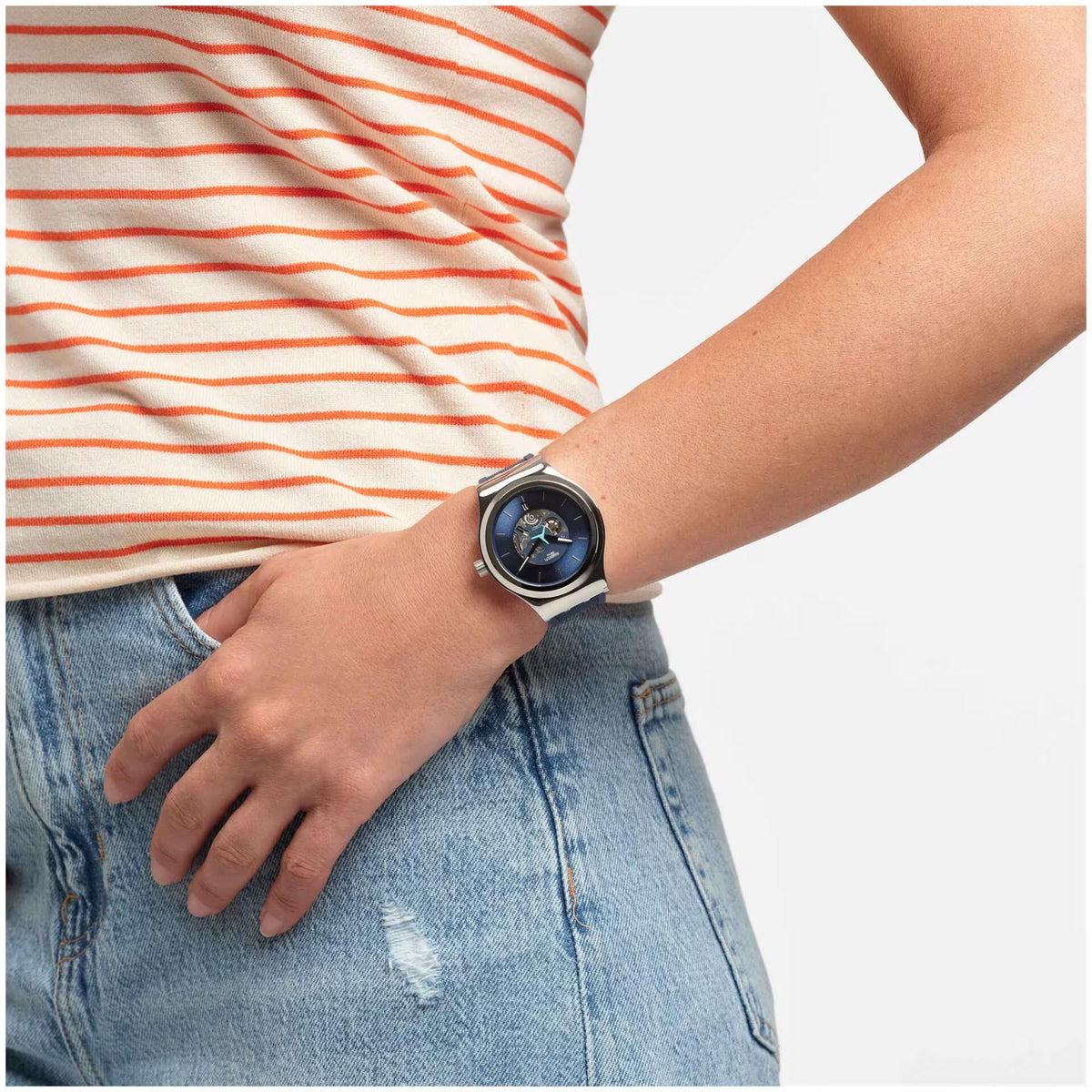 Men's Swatch watch on wrist with blue dial and blue rubber strap