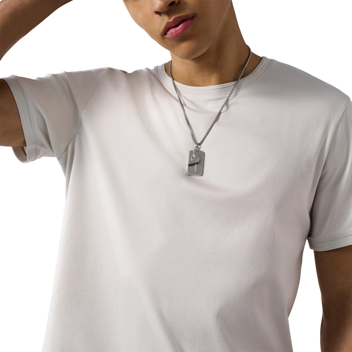 Stainless steel dog tag pendant necklace worn on chest with cable chain