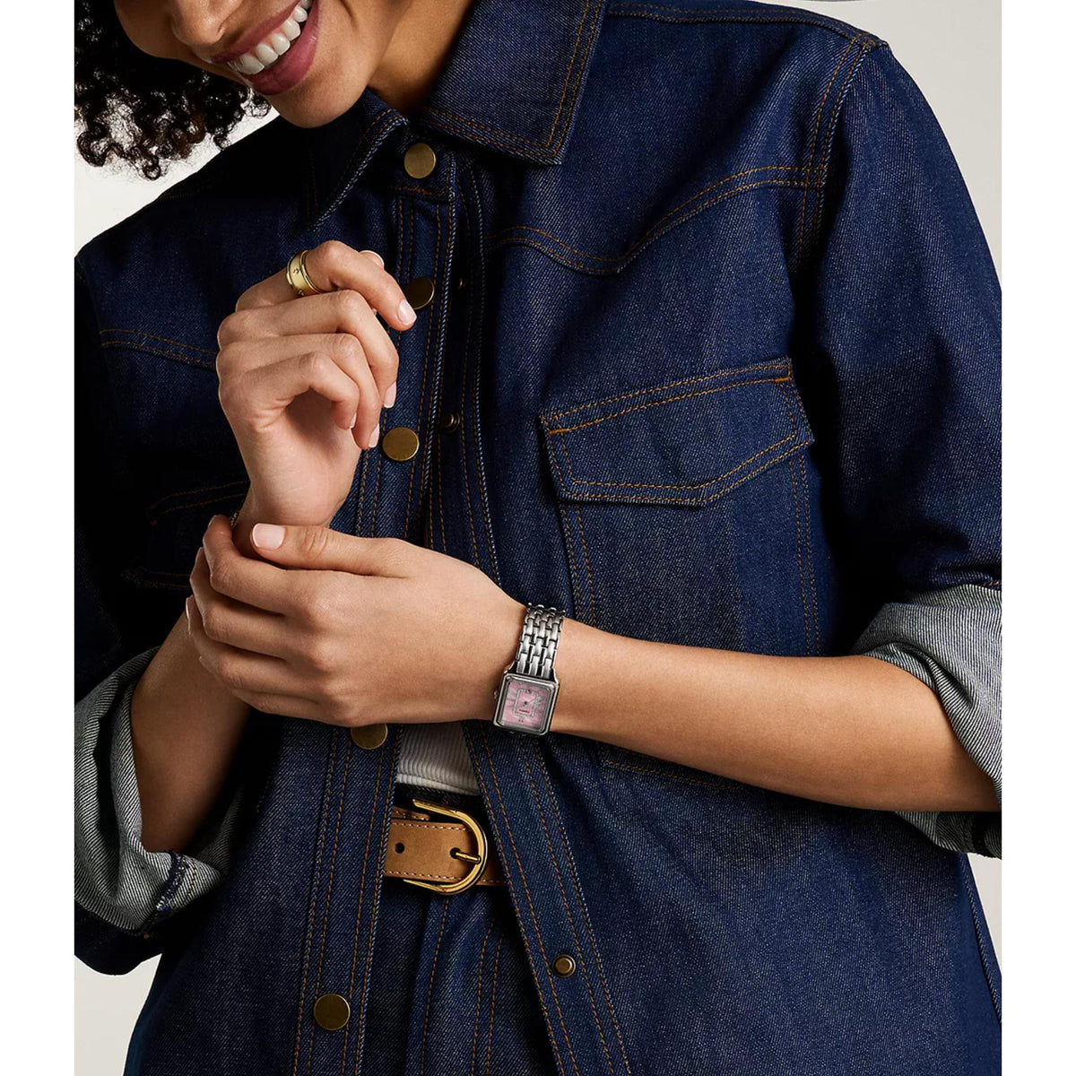 Ladies stainless steel quartz watch with pink mother-of-pearl dial, worn on wrist