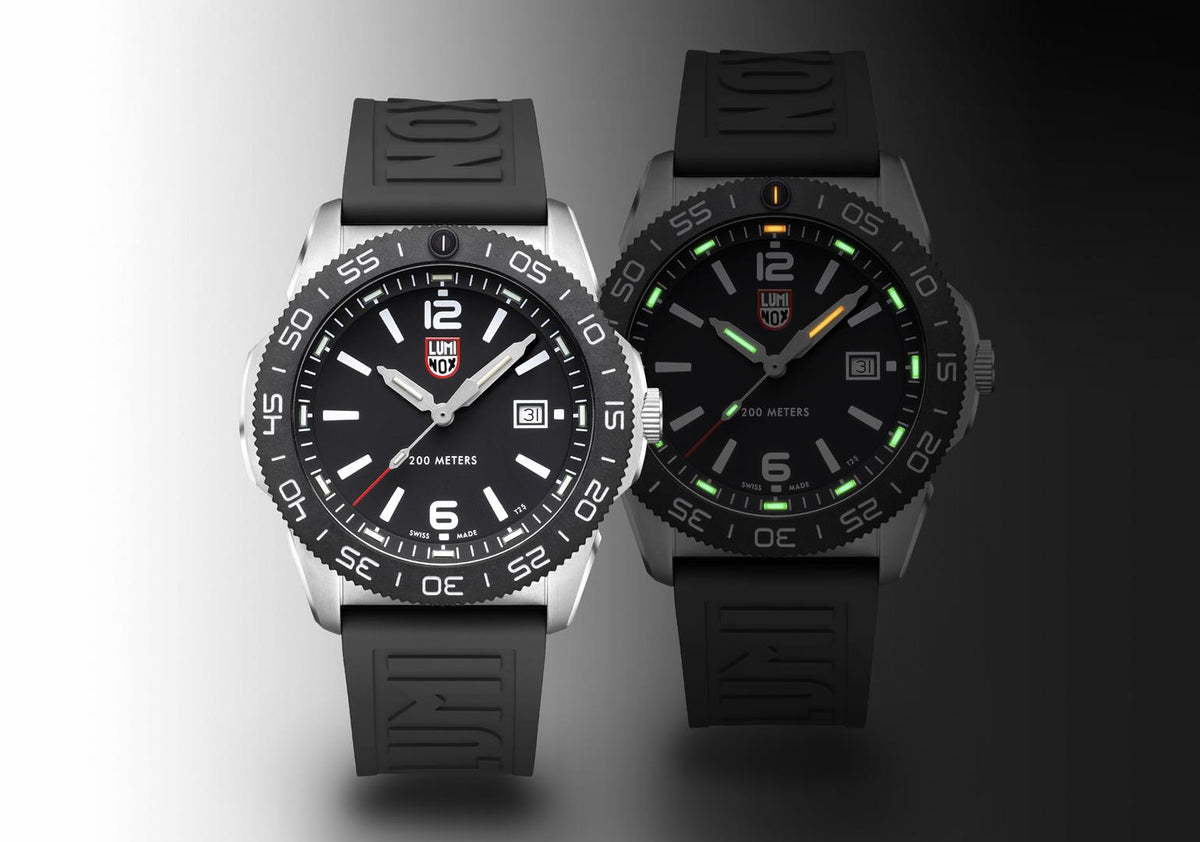 Men's diver watch pair shown side by side, black dial and black rubber straps.