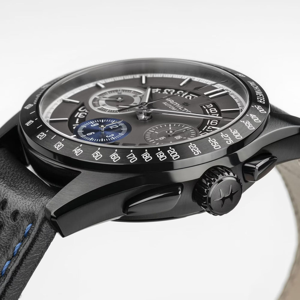 Men's automatic chronograph watch with black case and black leather strap with blue stitching
