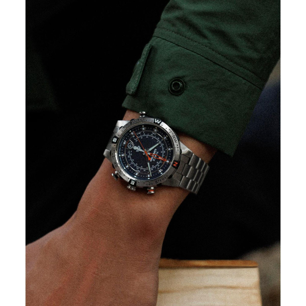 Men's steel quartz watch worn on wrist with blue dial and dark bezel markings