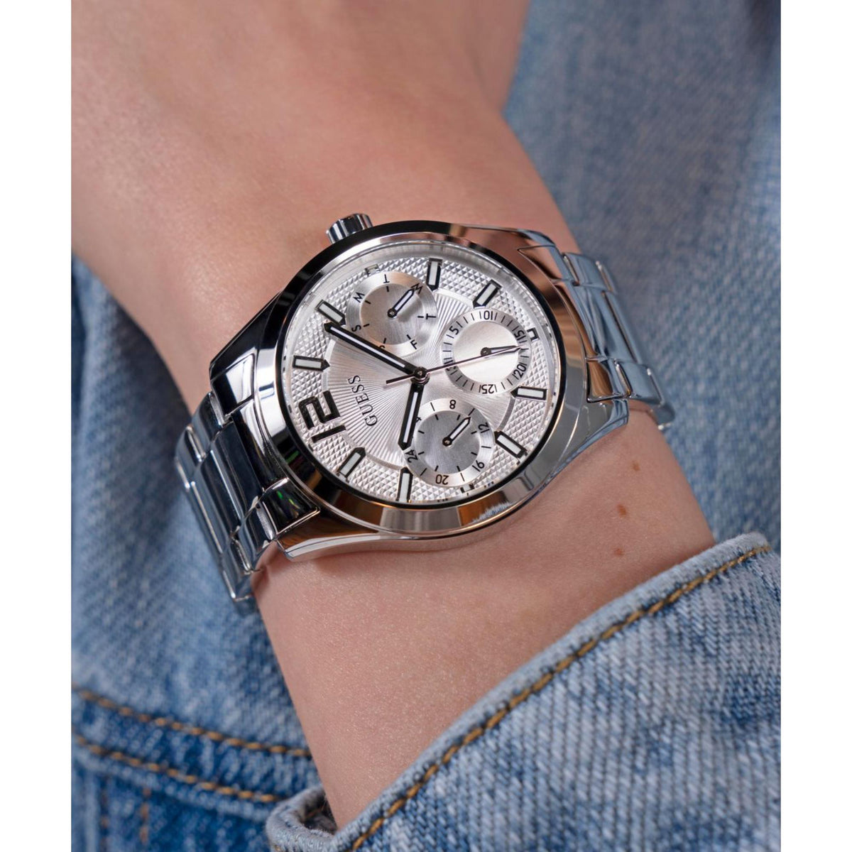 Guess Zoe silver stainless steel women's watch on wrist, side angle showing polished case