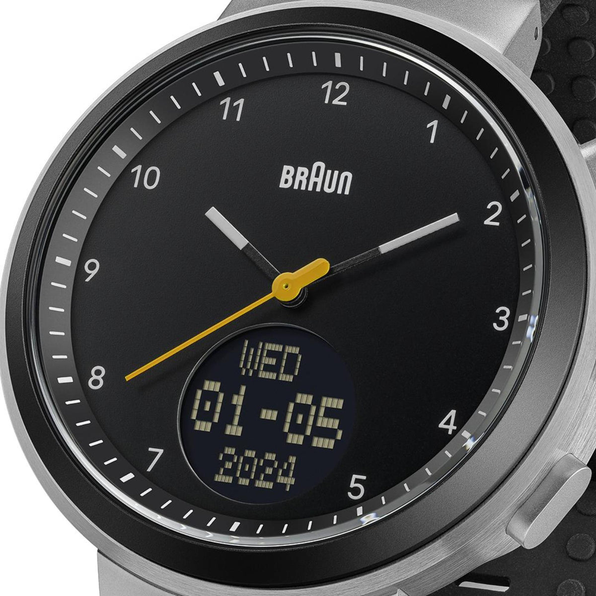 Braun Step watch close-up: black dial with digital time/date and yellow hands