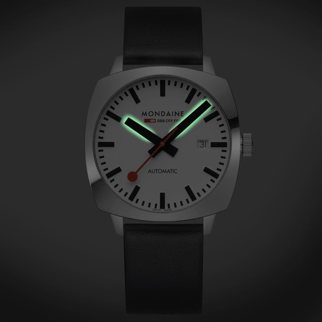 Mondaine Cushion automatic watch with white dial, black leather strap, silver case, date window