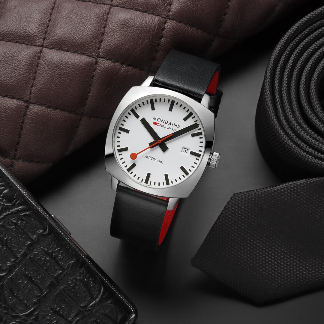 Mondaine men's automatic watch with white dial, black leather strap, red accents