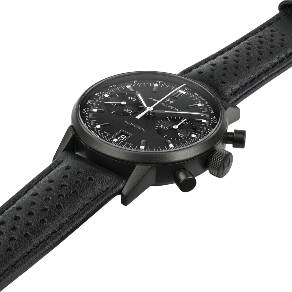 Black dial chronograph watch with perforated black leather strap and crown