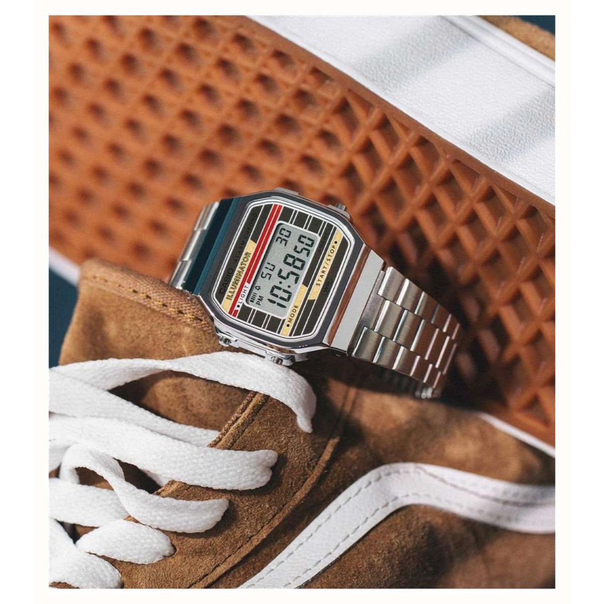 Close-up detail of the Casio Vintage Digital watch A168WEHA-9AEF resting on a brown suede sneaker