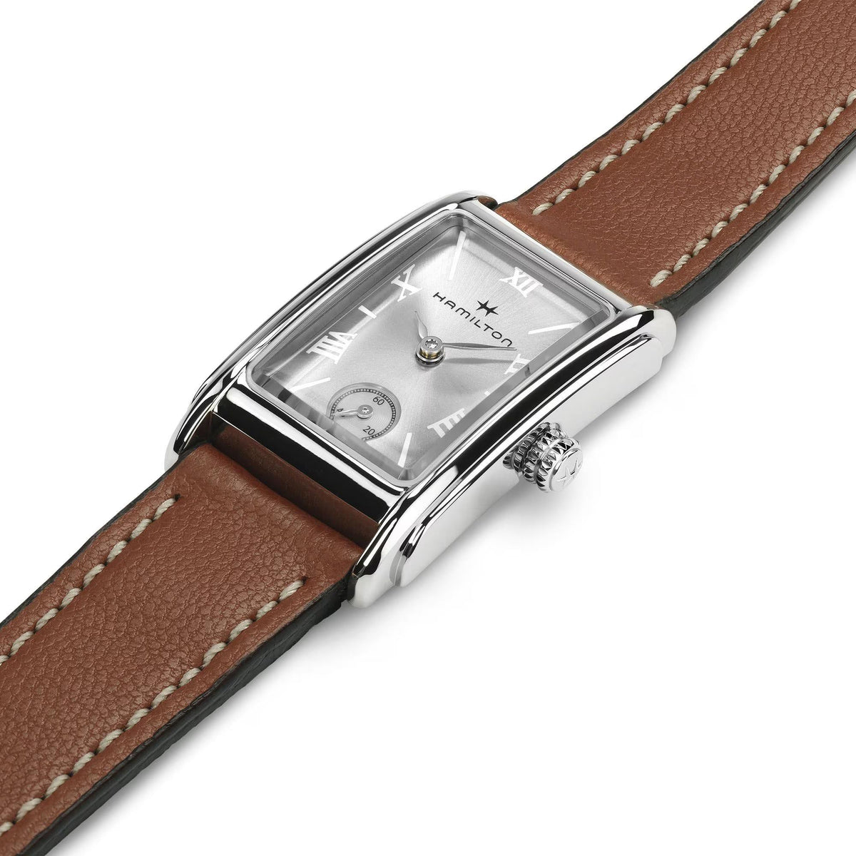 Silver-tone watch case with brown leather strap and silver dial, angled close-up