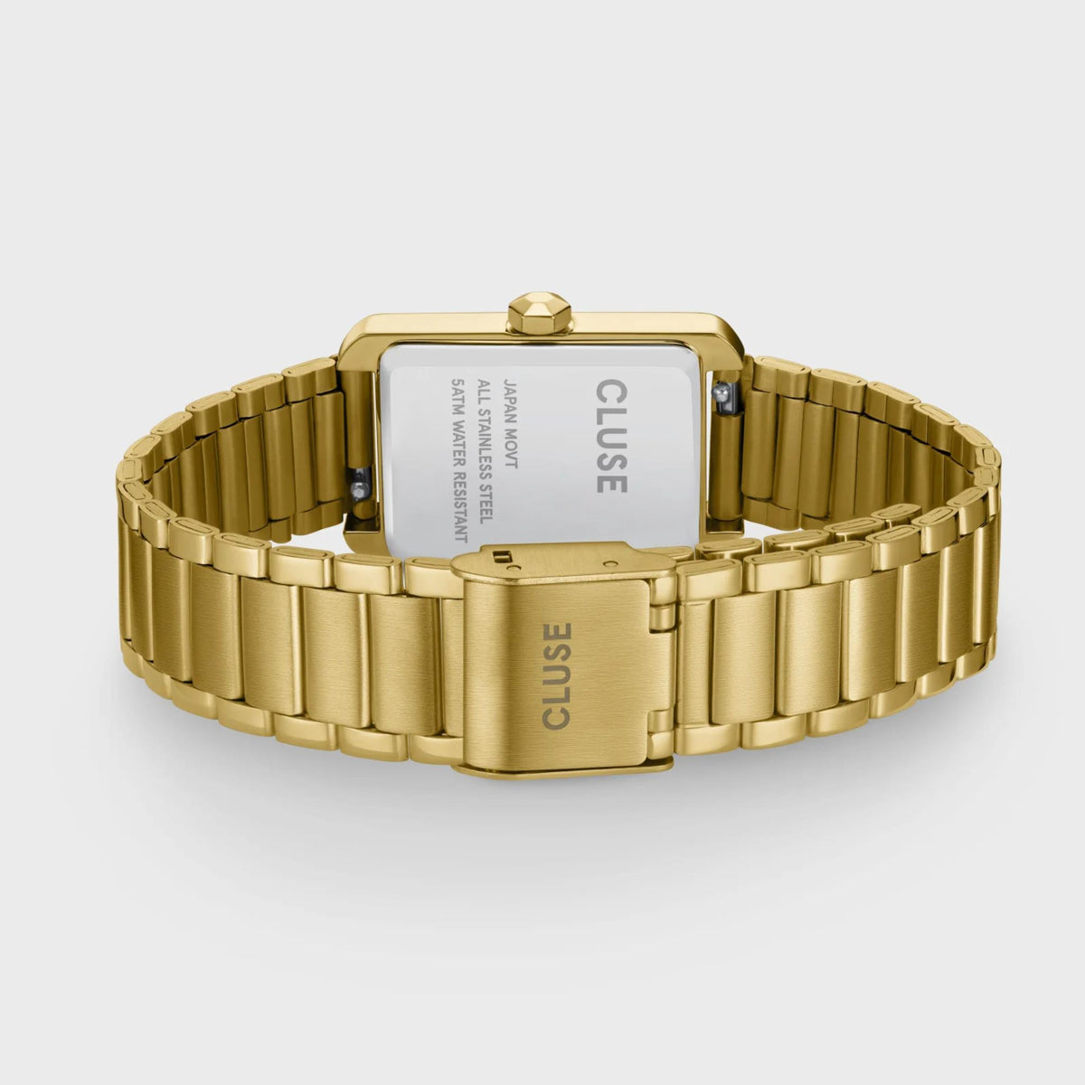 Gold-tone watch case back with CLUSE marking and rectangular link bracelet